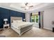 Cozy main bedroom featuring a tray ceiling, a large window, and a decorative headboard at 30 Hollyhock Ln, Covington, GA 30014