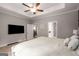 Spacious main bedroom with a TV and dual doorways to the bathroom and closet at 30 Hollyhock Ln, Covington, GA 30014