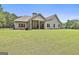 Spacious, fenced backyard featuring a covered patio, offering an ideal setting for outdoor activities and relaxation at 45 Coral Ridge Ct, Palmetto, GA 30268