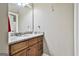 Bathroom featuring granite countertop, wooden cabinets, mirror, and modern fixtures at 45 Coral Ridge Ct, Palmetto, GA 30268
