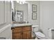 Bathroom featuring granite countertops, wood cabinets and a toilet at 45 Coral Ridge Ct, Palmetto, GA 30268