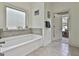 Bathroom with large soaking tub under a window and doorway to another room at 45 Coral Ridge Ct, Palmetto, GA 30268