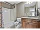 Bathroom featuring granite countertop, wooden cabinets, a shower and modern fixtures at 45 Coral Ridge Ct, Palmetto, GA 30268
