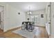 Bright dining area features modern light fixture, geometric rug, and views from a large window at 45 Coral Ridge Ct, Palmetto, GA 30268
