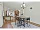 Well-lit dining area is adjacent to the kitchen and features hardwood floors and modern lighting at 45 Coral Ridge Ct, Palmetto, GA 30268