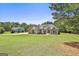 Spacious craftsman-style house featuring an expansive front yard with lush landscaping and long driveway at 45 Coral Ridge Ct, Palmetto, GA 30268