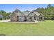 Inviting single Gathering home with stone accents, manicured landscaping, and well-maintained lawn at 45 Coral Ridge Ct, Palmetto, GA 30268