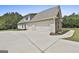 Detached garage with plenty of room for multiple cars and lush landscaping on the side at 45 Coral Ridge Ct, Palmetto, GA 30268