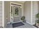 Close up of the front door with a decorative wreath, planters, and stylish rug at 45 Coral Ridge Ct, Palmetto, GA 30268