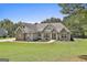Beautiful single Gathering home with stone accents, mature trees, and manicured lawn at 45 Coral Ridge Ct, Palmetto, GA 30268