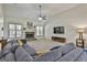 Open-concept living room with a stone fireplace, comfortable seating, and a vaulted ceiling with fan at 45 Coral Ridge Ct, Palmetto, GA 30268