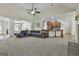 Open-concept living room featuring a stone fireplace, a plush gray sofa, and bright natural light at 45 Coral Ridge Ct, Palmetto, GA 30268