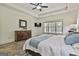 Light-filled main bedroom with modern grey floors, and wooden bedroom furniture at 45 Coral Ridge Ct, Palmetto, GA 30268