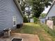 A view of the backyard featuring a shed, a small patio, and lush greenery at 435 Rosehill Dr, Mcdonough, GA 30253