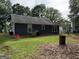 Exterior backyard view with lush lawn and tree coverage around the home at 435 Rosehill Dr, Mcdonough, GA 30253
