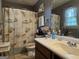 Bathroom featuring a shower/tub combo with nautical-themed curtain, vanity, and a toilet at 435 Rosehill Dr, Mcdonough, GA 30253
