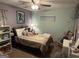 Comfortable bedroom with light green walls, a cozy single bed, and decorative wall art at 435 Rosehill Dr, Mcdonough, GA 30253