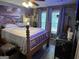 Inviting main bedroom with a wooden four poster bed frame, dark floors, and modern fixtures at 435 Rosehill Dr, Mcdonough, GA 30253