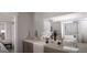 Bathroom featuring double sinks and a large mirror, complemented by granite countertops at 1208 Trombone Way # 106, Mcdonough, GA 30252