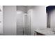 Bathroom with tiled shower, glass doors, and a vanity featuring granite countertops at 1208 Trombone Way # 106, Mcdonough, GA 30252