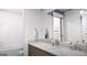 Elegant bathroom featuring dual sinks, granite countertops, and a large mirror at 1208 Trombone Way # 106, Mcdonough, GA 30252