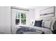 Bright bedroom featuring a large window, comfortable bed, and stylish decor at 1208 Trombone Way # 106, Mcdonough, GA 30252