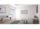 Bright bedroom with neutral colors, playful decor, and a comfortable bed at 1208 Trombone Way # 106, Mcdonough, GA 30252