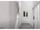 Bright hallway with decorative wall plates and gray wood flooring that leads to the front door at 1208 Trombone Way # 106, Mcdonough, GA 30252