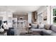 Open-concept living space with a modern kitchen, stylish seating, and expansive windows at 1208 Trombone Way # 106, Mcdonough, GA 30252