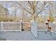 Wooden back deck overlooks a large lot with multiple outbuildings, perfect for outdoor enjoyment at 435 Crabapple Rd, Fayetteville, GA 30215