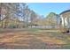 Expansive backyard featuring a lush lawn and mature trees providing shade and privacy at 435 Crabapple Rd, Fayetteville, GA 30215