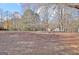 Expansive backyard with leafy trees and a canopy of fallen leaves, providing a large outdoor area at 435 Crabapple Rd, Fayetteville, GA 30215