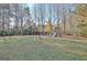 Large backyard features mature trees and a play set for outdoor fun at 435 Crabapple Rd, Fayetteville, GA 30215