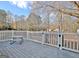 Backyard deck with white railing, picnic table, and views of mature trees at 435 Crabapple Rd, Fayetteville, GA 30215