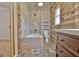Renovated bathroom with a tub, toilet, modern vanity, and wood-look planked wall at 435 Crabapple Rd, Fayetteville, GA 30215