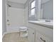 Updated bathroom featuring a shower-tub combo, white vanity, and neutral tile floors at 435 Crabapple Rd, Fayetteville, GA 30215