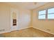 Bedroom with parquet flooring, neutral walls, door with mirror and bright window at 435 Crabapple Rd, Fayetteville, GA 30215