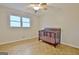 Bedroom with parquet flooring, and a crib under a bright window at 435 Crabapple Rd, Fayetteville, GA 30215