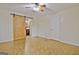 Bedroom featuring a wooden sliding barn door for bathroom access, parquet floors, and a ceiling fan at 435 Crabapple Rd, Fayetteville, GA 30215