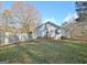 View of the home's side and backyard, showcasing a well-maintained lawn and white picket fence at 435 Crabapple Rd, Fayetteville, GA 30215