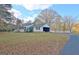 This home features a covered parking area, a long driveway, and beautiful surrounding trees at 435 Crabapple Rd, Fayetteville, GA 30215