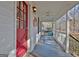 Charming front porch with a red door, a ceiling fan, and a relaxing porch swing at 435 Crabapple Rd, Fayetteville, GA 30215