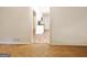 Hallway view with hardwood flooring and access to the kitchen and other rooms at 435 Crabapple Rd, Fayetteville, GA 30215