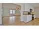 Open kitchen connected to living area with white cabinets and stainless steel oven at 435 Crabapple Rd, Fayetteville, GA 30215