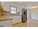 Sunlit kitchen with white cabinets, granite countertops, and stainless steel fridge at 435 Crabapple Rd, Fayetteville, GA 30215