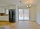 Bright eat-in kitchen with stainless steel fridge and sliding glass doors to the deck at 435 Crabapple Rd, Fayetteville, GA 30215