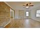 Inviting living room features wood-style floors and a stone accent wall for a cozy and stylish space at 435 Crabapple Rd, Fayetteville, GA 30215