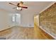 Spacious living room with hardwood floors, ceiling fan, and a unique wood accent wall at 435 Crabapple Rd, Fayetteville, GA 30215
