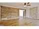 Open-concept living room boasts wood-style floors and wood accent wall, creating a modern and inviting space at 435 Crabapple Rd, Fayetteville, GA 30215