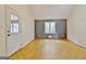 Bright living room with wood paneling, an exterior door, and large windows at 435 Crabapple Rd, Fayetteville, GA 30215
